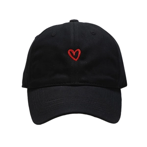 Minimalist black cotton baseball cap with red heart embroidery on a white background