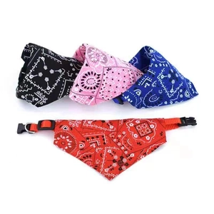 Detail view of adjustable pet bandana collars in paisley pattern with plastic buckle