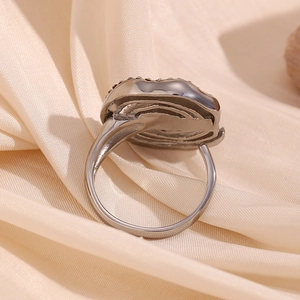 Macro view showing the detailed silver finish craftsmanship of the spiral wrap ring