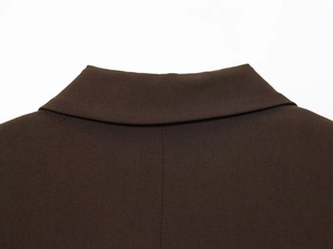 Detailed close-up of dark brown blazer collar with high-quality stitching and fabric texture