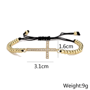 Detailed dimensions showing the 3.1cm cross charm on a gold-plated beaded drawstring bracelet
