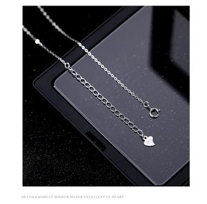 Macro detail of S925 sterling silver necklace clasp and heart pendant with hallmark