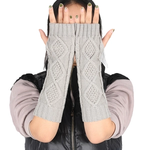 Detail of grey diamond-patterned knitted arm warmers with fingerless design for women