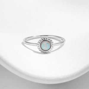 Elegant s925 silver sunflower ring with round opal stone on white ceramic plate