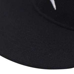 Detail of six-row stitching on the brim of a black cotton baseball cap with white embroidery