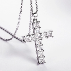 Silver cross necklace with square-cut zircons shown in a 45-degree angle profile view