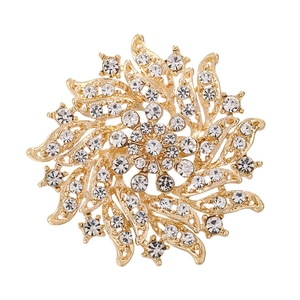 Golden sunburst brooch pin with sparkling white rhinestones in a swirl flower design