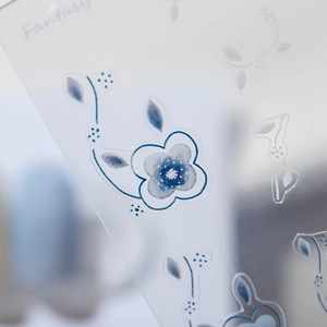Blue floral nail art stickers with thin adhesive backing on transparent sheet