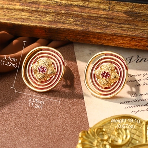 Detailed macro view of vintage red enamel spiral earrings with dimensions and weight info