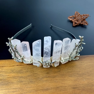 Detailed macro view of pink crystal crown with silver wire moon and star ornaments