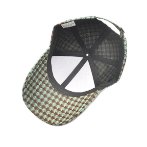 Inside view of houndstooth baseball cap showing sweatband and adjustable buckle