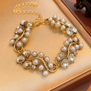 Detailed close-up of a vintage gold bracelet with white pearls and sparkling crystals