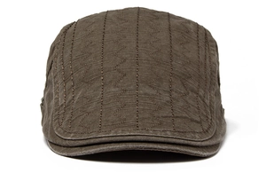 Detail of dark brown cotton flat cap showing unique vertical wavy stitching and texture