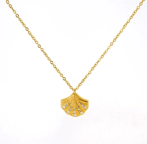 Detail of gold fan-shaped shell necklace with radiant textures and sparkling stones