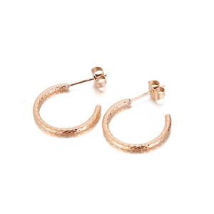 Elegant rose gold C-shaped hoop earrings with a hammered textured finish on white background