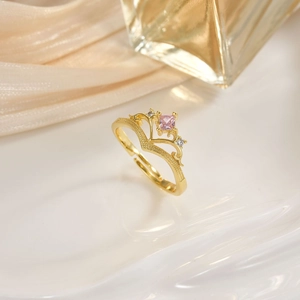 Detailed side view of a gold crown ring with a pink square zircon and micro diamonds