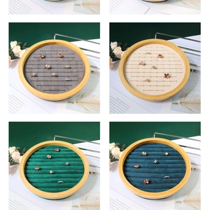 Detail view of round bamboo jewelry trays with velvet ring slots in four colors
