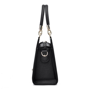Elegant black Saffiano leather tote bag with gold hardware shown in a side profile view