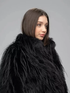 Detail of black thick faux fur jacket showing long plush texture and premium softness
