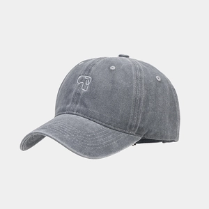 Macro detail of dark grey washed cotton baseball cap with white minimalist embroidery