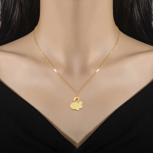 Elegant gold swan necklace in titanium steel with delicate hollow pattern worn by a model