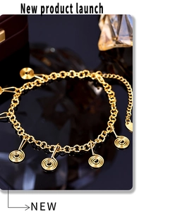 Macro shot of gold-plated twisted pendant bracelet with adjustable lobster clasp