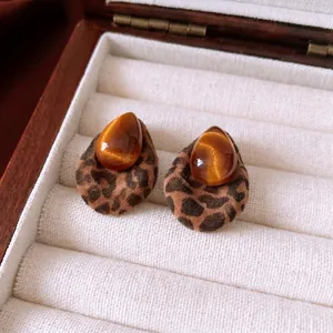 Leopard print base and teardrop opal earrings displayed in a white jewelry gift box
