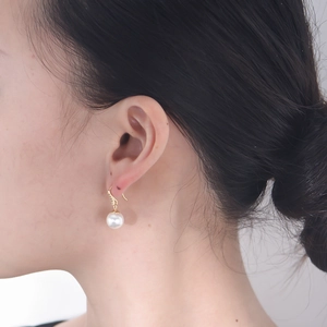 Elegant 925 sterling silver pearl drop earrings worn by a model in a minimalist style