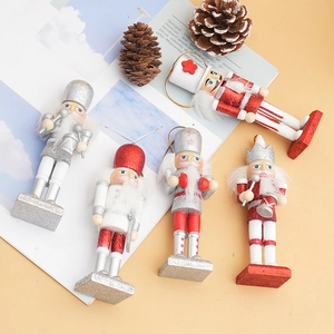 Set of five wooden glitter nutcracker ornaments with festive red and silver soldiers