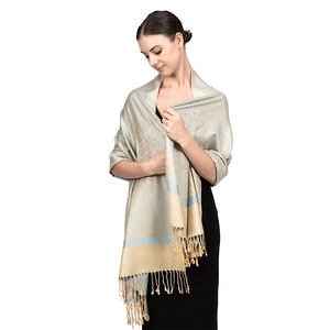 Detail of light blue and gold paisley jacquard pattern with fringe on luxury shawl