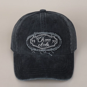 Detailed close-up of distressed denim baseball cap with vintage patch embroidery