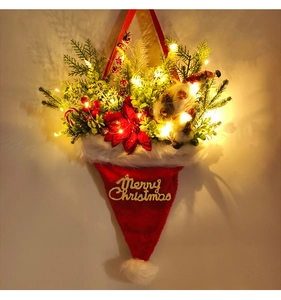 Detail of Christmas hat wall planter with LED lights, pine needles and red berries