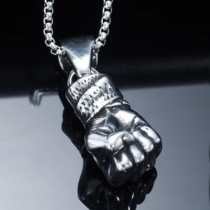 Polished stainless steel fist pendant on a box chain with a deep mirror reflection