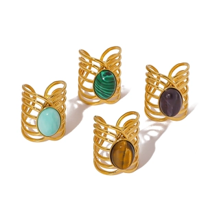 Set of four gold stainless steel rings with colorful turquoise stones on white background