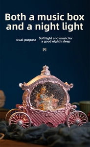 Detailed view of pink princess carriage music box with warm LED light and crown top detail
