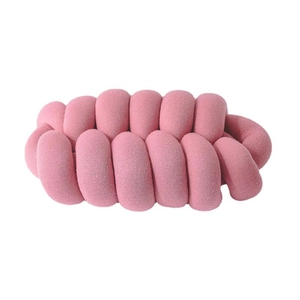 Pink chunky knit knot pillow made of soft woven fabric for sofa or office decor