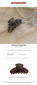 Detailed view of large resin hair claw clips with elegant lace embroidery texture