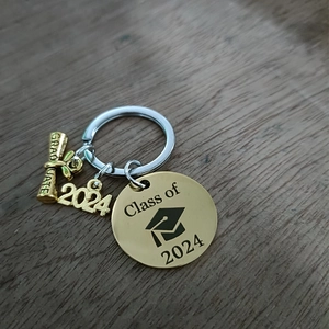 Detail of 2024 graduation keychain with gold Graduate scroll and Class of 2024 charm