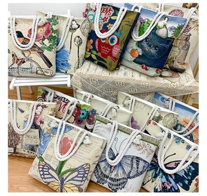 Macro view of canvas tote bags featuring thick cotton rope handles and diverse floral prints