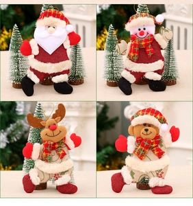 Close-up of four plush Christmas ornaments including Santa, Snowman, Reindeer, and Bear