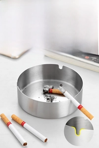Detail of silver stainless steel ashtray showing 3 U-shaped cigarette slots and brushed finish