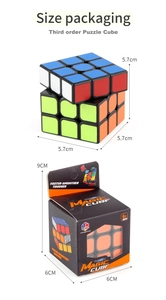 Close-up of a 5.7cm 3x3 educational puzzle cube next to its black window packaging box