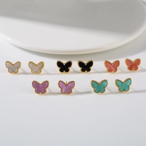 Detailed macro shot of five pairs of colorful butterfly stud earrings with gold bead edges