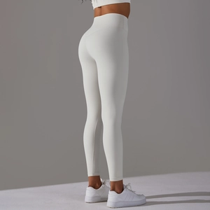 Close-up of white high-waisted seamless yoga leggings with peach lift effect on hips