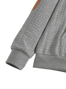 Detail of grey quilted waffle texture fabric with ribbed cuffs on men's hoodie