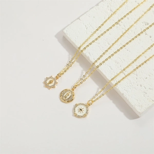 Macro view of 14K gold plated necklaces featuring star and oval virgin mary pendants