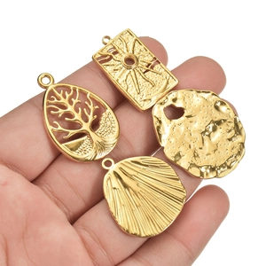 Set of four gold stainless steel tree of life and sun charms for DIY jewelry making