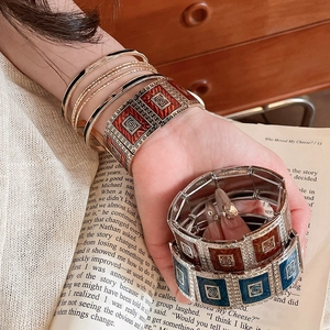 Detailed close-up of Bohemian enamel square splice bracelets in diverse earthy vintage colors