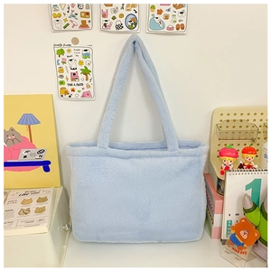 Detailed close-up of light blue plush faux fur texture on a large capacity tote bag