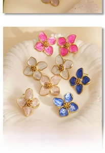 Colorful petal earrings in 316L stainless steel displayed on white ceramic plate